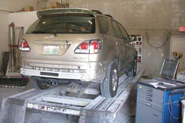 An SUV up on our frame straightening machine.